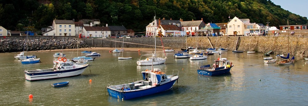 View across Minehead harbour with fishing boats at low tide